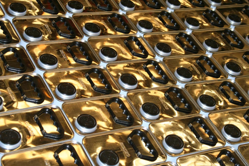 Gold topped rectangular cans of paint