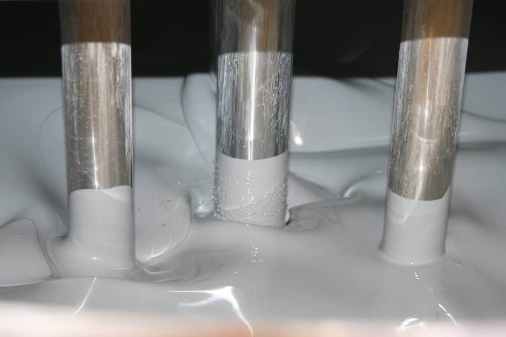 Paint manufacturing showing 3 disperser shafts in grey paint being made