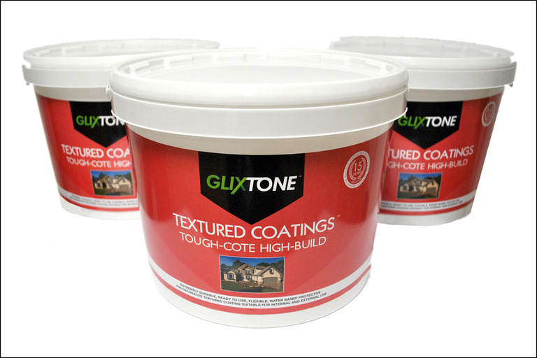 Plastic tubs of Glixtone Tough-Cote textured masonry coating on a pale grey background.